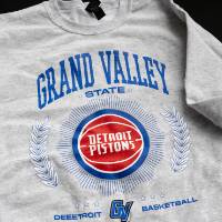 Close up shot of Grand Valley and Pistons custom crewneck